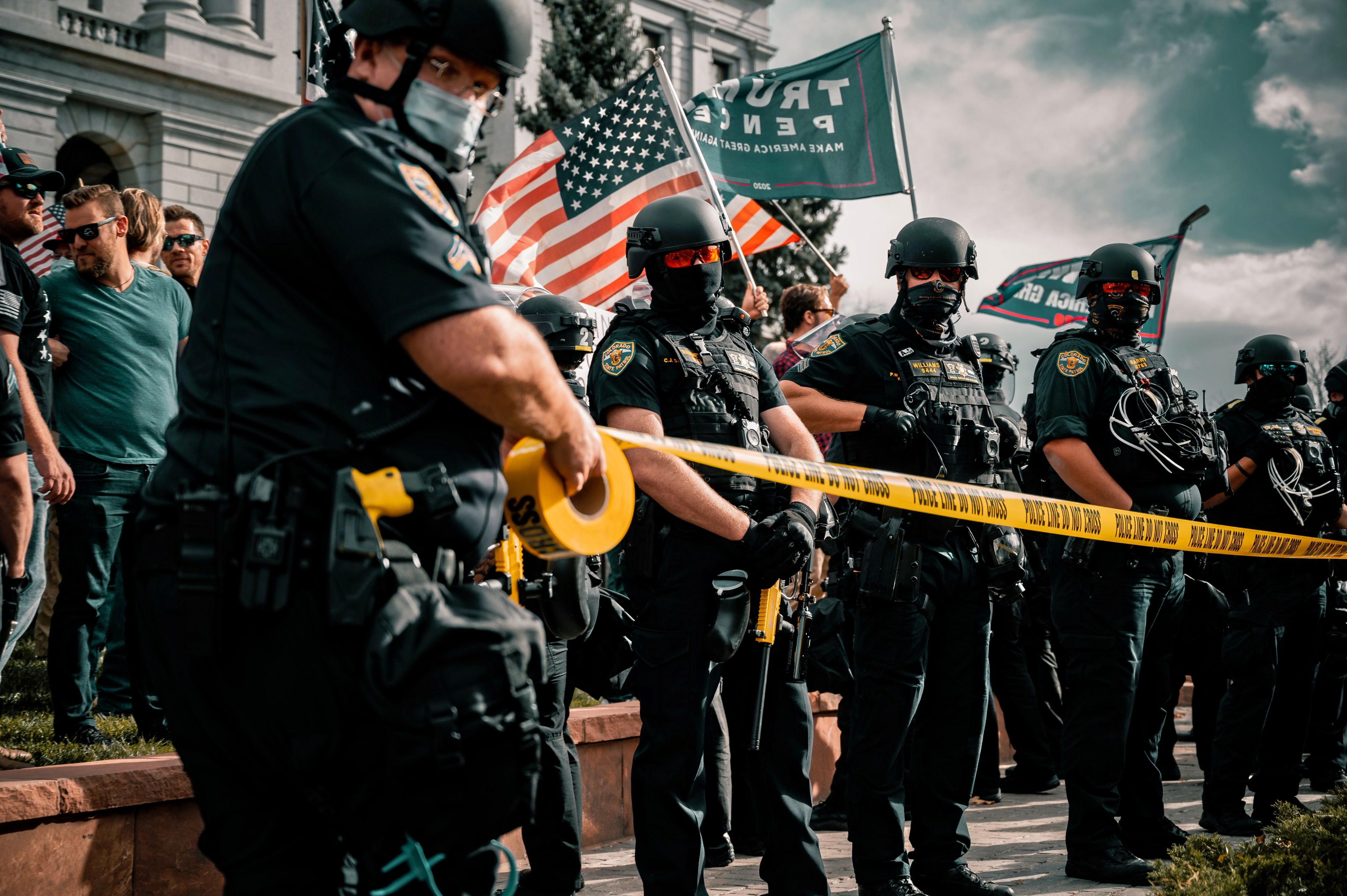 man in black shirt holding american flag